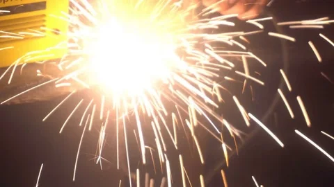 The process of manufacturing a decorative metal product. Metal sparks fly apart Video stock 83328410
