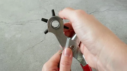 The process of manufacturing a leather belt by tanner. Puncture holes in the  Stock-Footage 165322017