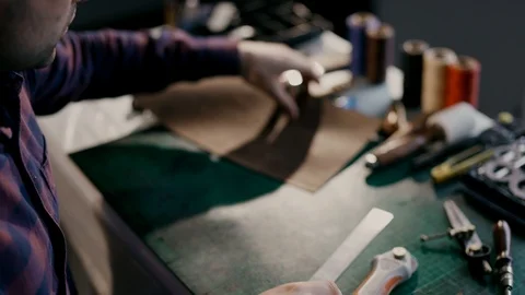 The process of manufacturing a leather wallet handmade. The wizard makes a mark Stock Footage 91071560