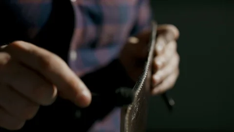 The process of manufacturing a leather wallet handmade. The craftsman grinds the Stock Footage 95216962