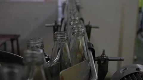 The process of manufacturing line production of juice bottling on conveyor li Stock Footage 143407442