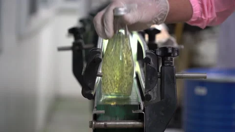 The process of manufacturing line production of juice bottling on conveyor li Stock Footage 159659388