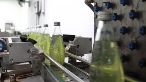 The process of manufacturing line production of juice bottling on conveyor li Stock Footage 159659920