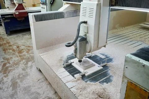 The process of manufacturing a part of complex shape from plastic on a CNC Stock Photos