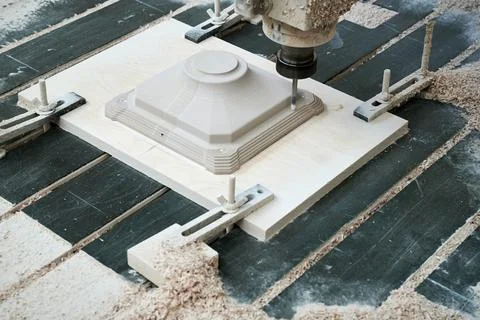 The process of manufacturing a part of complex shape from plastic on a CNC Stock Photos