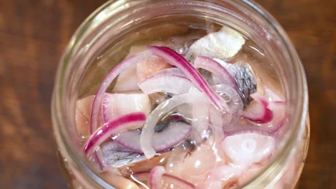 The process of marinating herring with onions in a jar Stock Footage 255039883