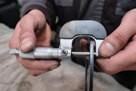 The process of measuring the ring of a large diesel engine in a machine-build Stock Photos