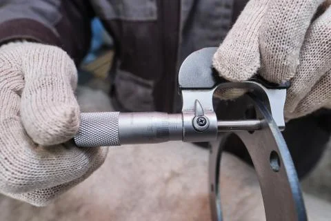 The process of measuring the ring of a large diesel engine in a machine-build Stock Photos