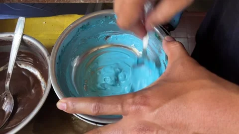 The process of melting blue chocolate on a stainless steel plate Video stock 308639602