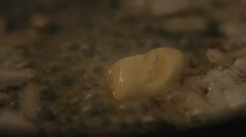 Process of melting butter on a hot frying pan with sizzling onions Stock Footage 62476463