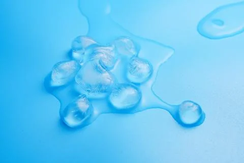 The process of melting ice cubes on a blue Stock Photos