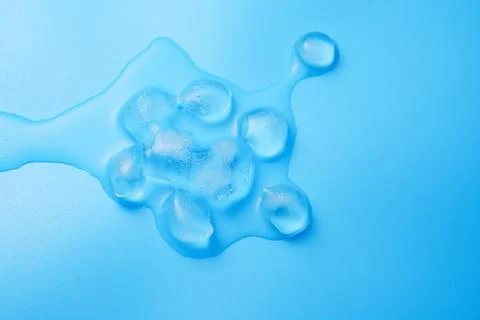The process of melting ice cubes on a blue Stock Photos
