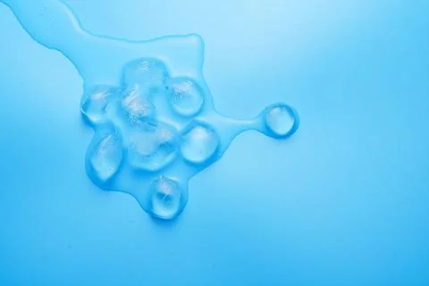 The process of melting ice cubes on a blue Stock Photos