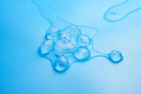 The process of melting ice cubes on a blue Stock Photos