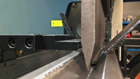 The process of metal bending on a CNC bending machine. Bending of metal using a Stock Footage 165996857