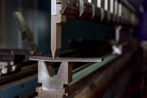 The process of metal bending on a CNC bending machine. Bending of metal using a Stock Photos