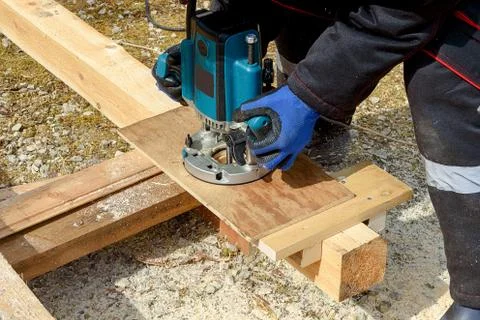 The process of milling wood with a circular machine. Passion for wood carving Stock Photos