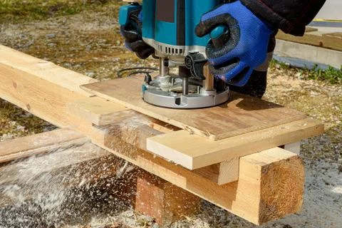 The process of milling wood on a round machine. Passion for wood carving. Pro Stock Photos