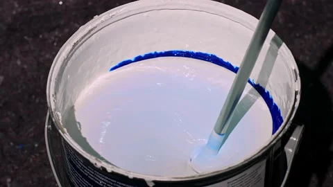 The process of mixing the blue paint in a bucket with a mixer. Mixing paint in a Stock Footage 139160631