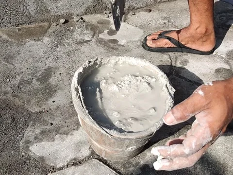Process of mixing cement and water to make an cement dough for plastering walls Stock Footage 197707216