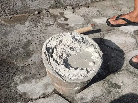 Process of mixing cement and water to make an cement dough for plastering walls Stock Footage 197707273