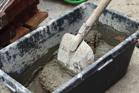 The process of mixing cement at a construction site for the construction of a Stock Photos