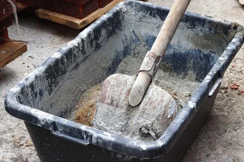 The process of mixing cement at a construction site for the construction of a Stock Photos