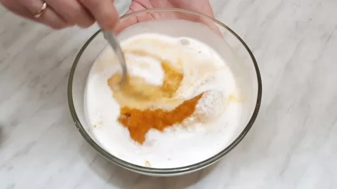 The process of mixing ingredients for pumpkin pie-kefir, semolina and pumpkin pu Stock Footage 143887438