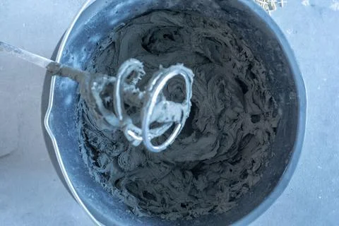 The process of mixing mortar with a perforator with a special nozzle Stock Photos