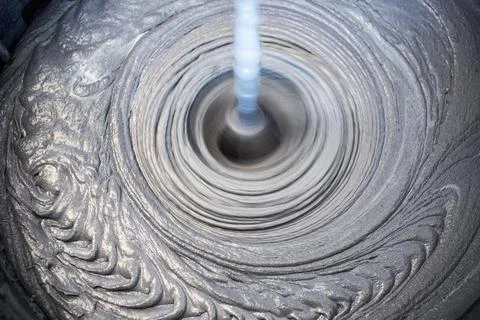 The process of mixing mortar with a perforator with a special nozzle Stock Photos