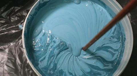 The process of mixing white paint with a color tinge in the bucket drill with a Stock-Footage 67295363