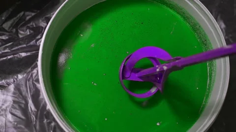 The process of mixing white paint with a color tinge in the bucket drill with a Stock Footage 67296141