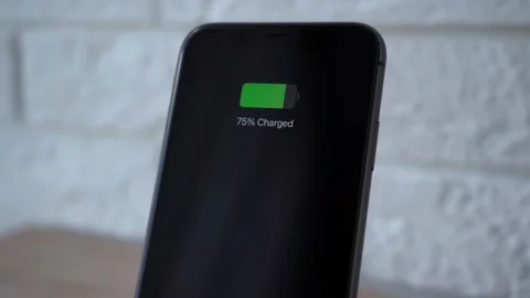 Process of mobile phone charging on an induction station pad. 4k stock footage. Vídeos de archivo 156420487