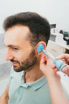 Process of molded individual hearing aid earmolds. A man, having procedure ma Fotos Stock