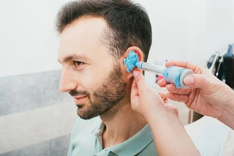 Process of molded individual hearing aid earmolds. A man, having procedure ma Фото