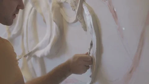 The process of molding stucco and bas-relief on the wall Stock Footage 73363224