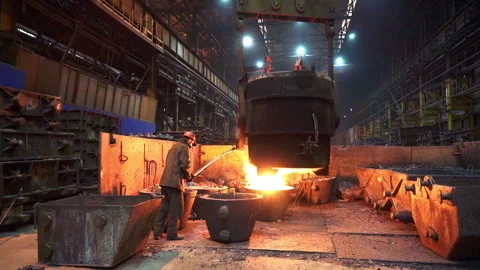The process of Molten Metal Casting takes place in an Industrial Foundry setting Stock Footage 283958730