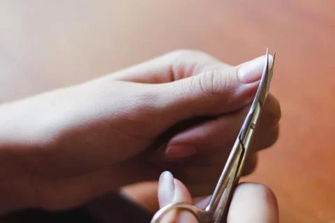 The process of nail clippingl scissors. Hand care concept. Soft focus. Foto stock