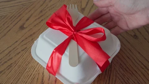 The process of opening asian bento cake box, female caucasian hand unties the Stock Footage 196241579