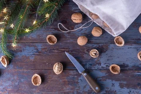 The process of opening walnuts with a small knife, whole nuts roll out of a l Stock Photos