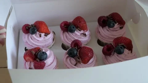 Process of packing fruit cupcakes in a white cardboard box. Stock Footage 135608862