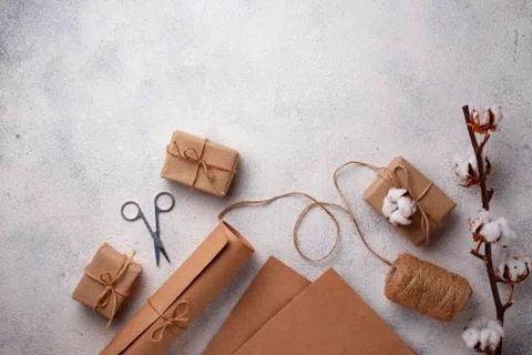 Process of packing gifts boxes in craft paper. Stock Photos