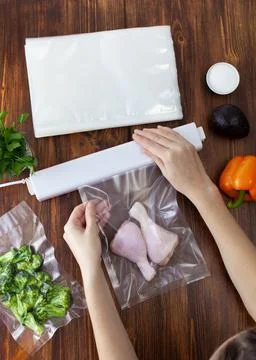The process of packing raw chicken legs in a vacuum bag Stock Photos