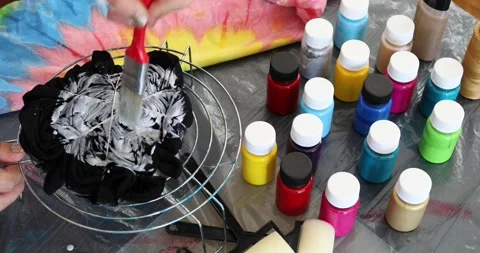 The process of painting in the style of tie dye to t-shirt 4 Stock Footage 135354964