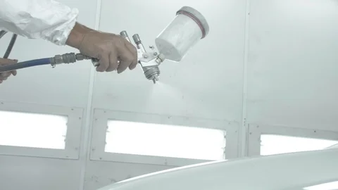 Process of painting a white car in a spray booth. Man using a spray gun 스톡 동영상 125884455