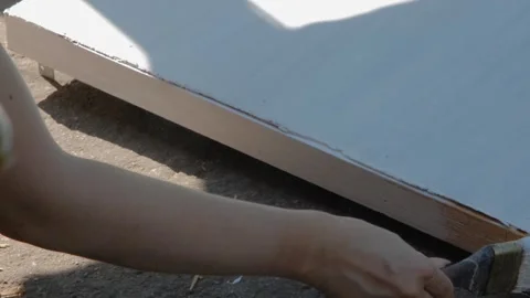 The process of painting with white paint. The brush paints the wooden part white Stock Footage 263149392