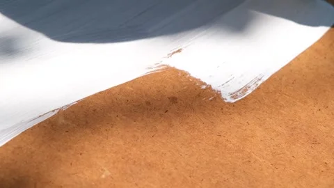 The process of painting with white paint. The brush paints the wooden part white Stock Footage 263731121