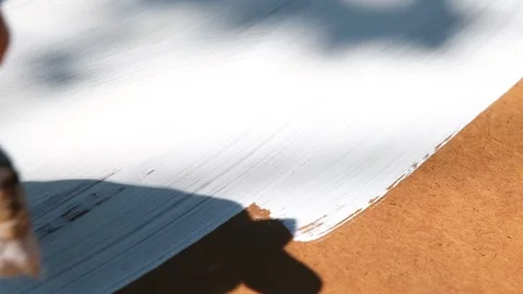 The process of painting with white paint. The brush paints the wooden part white Stock Footage 266340858