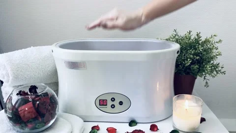 The process of paraffin therapy for hands in a spa salon. Stock-Footage 129465934