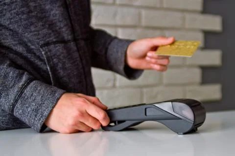 The process of payment for goods through the Terminal. Plastic card. Enter th Stock Photos